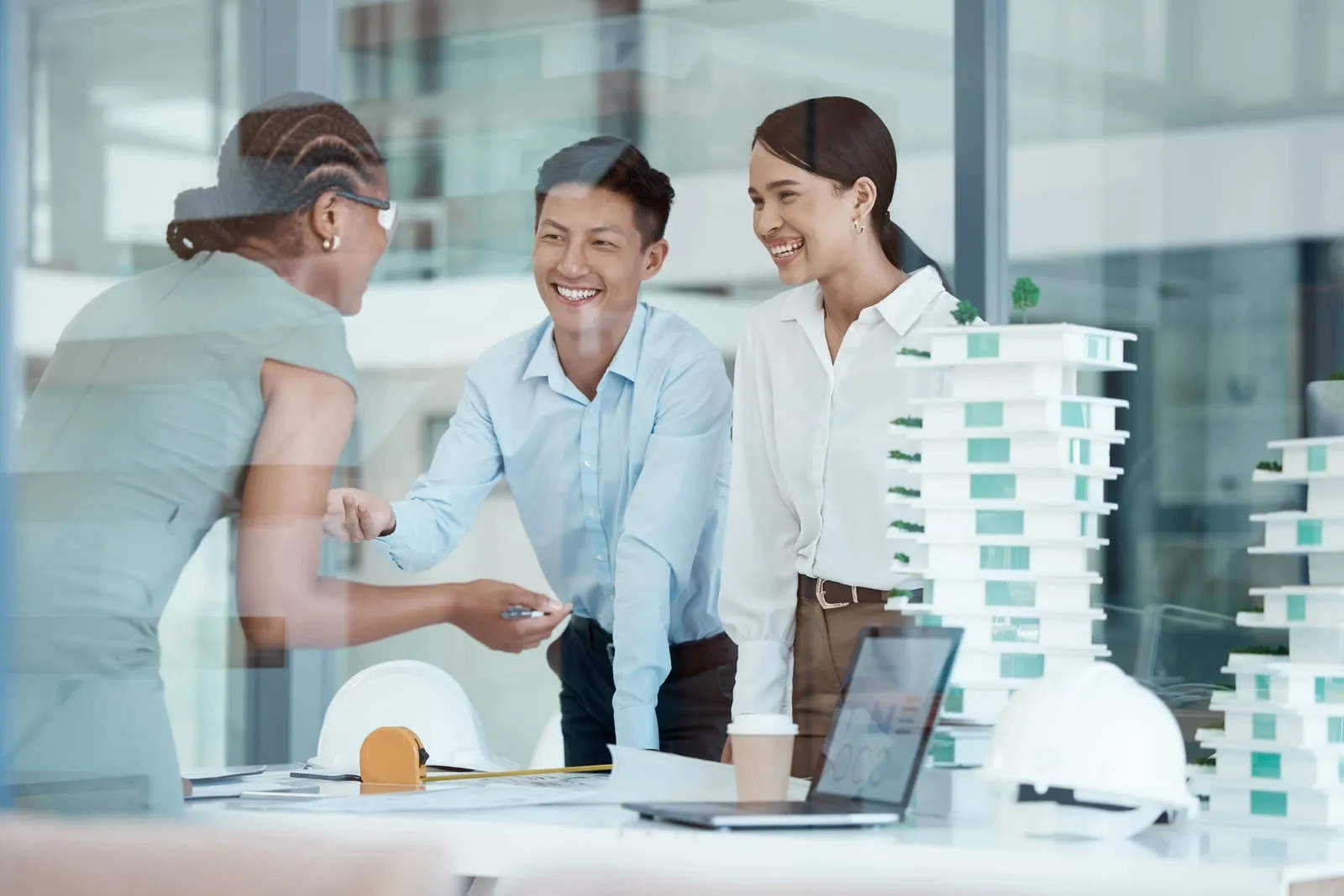 An architect and a designer reviewing a project model