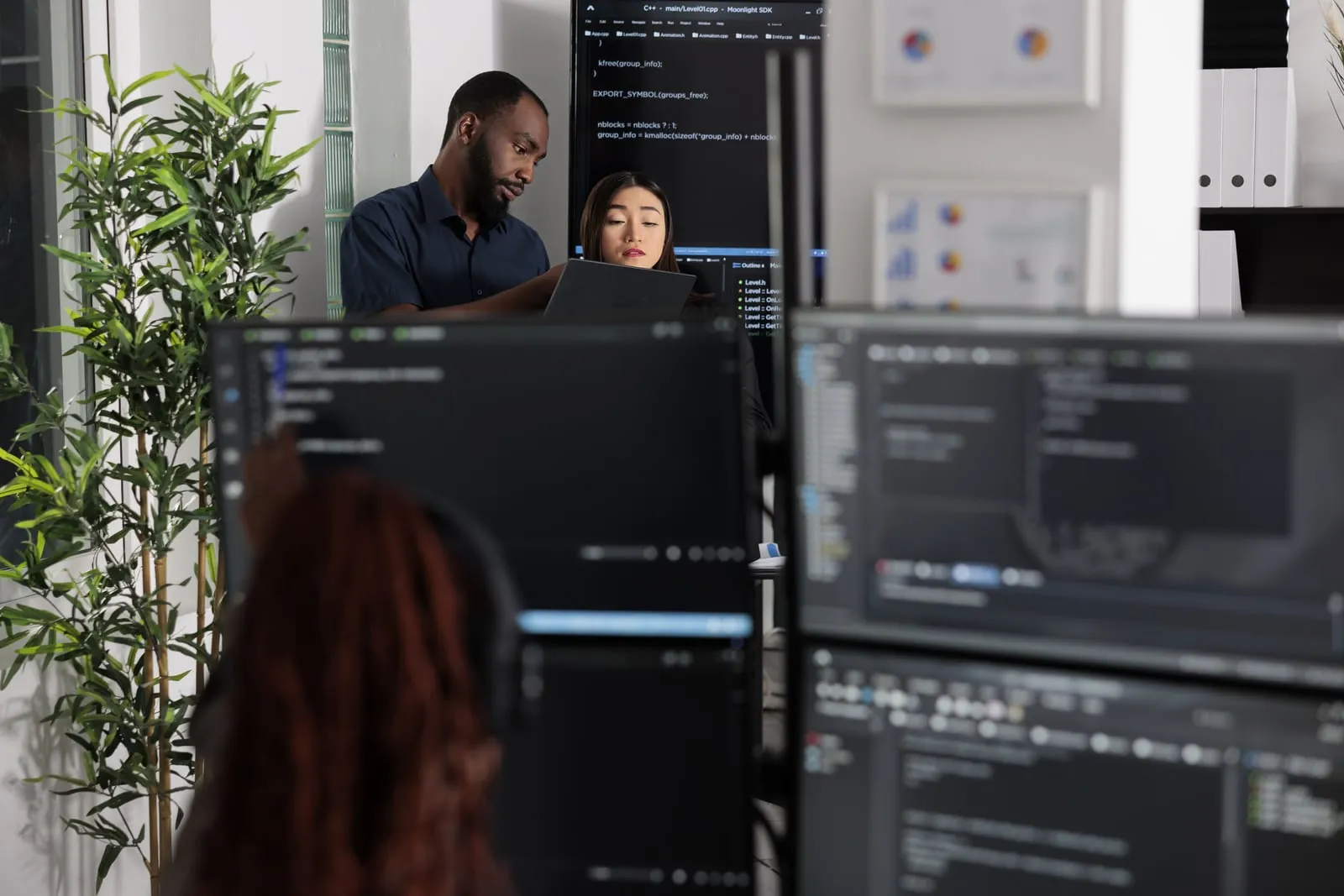 A team of app developers reviewing a coding algorithm